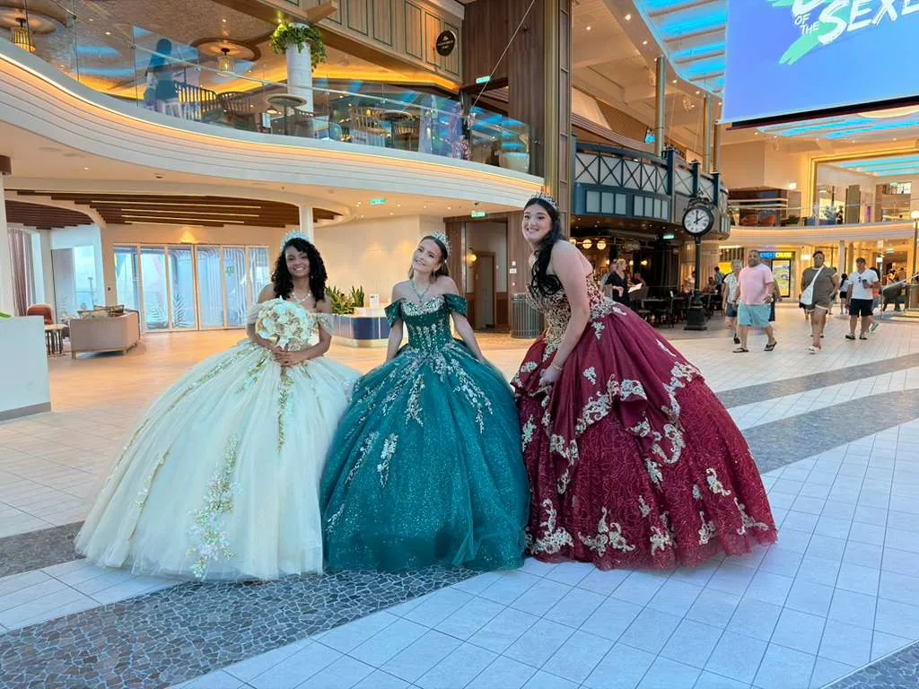 Quinceañeras in gala dresses exploring the ship