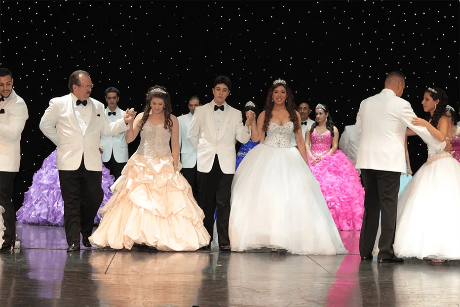 Quinceañeras dancing with their families at the Travel Angels gala