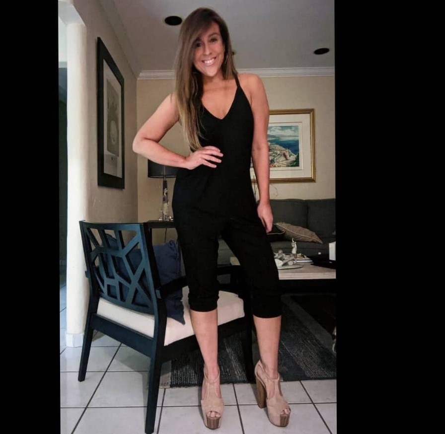 Wearing a black outfit indoors.